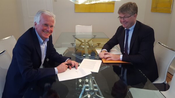 Notaris Paul Eversdijk en voorzitter Theo van Loon tekenen voor de oprichting van Stichting Leer Zelf Online.